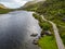 Aerial view of road and lake at Gap of Dunloe with rocks and vegetation