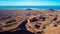 Aerial view of a road leading through vast area of volcanic land and mountains