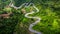 Aerial view road in mountains, Road running through green hills forest with car