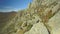 Aerial view of the rock cliffs. Shot. Rocky mountains and trees