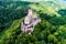 aerial view rock with medieval castle Ehrenburg on it near moselle river in Brodenbach with forest hills