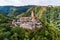 aerial view rock with medieval castle Ehrenburg on it near moselle river in Brodenbach with forest hills