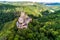 aerial view rock with medieval castle Ehrenburg on it near moselle river in Brodenbach with forest hills