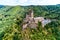 aerial view rock with medieval castle Ehrenburg on it near moselle river in Brodenbach with forest hills