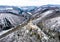 Aerial view rock with medieval castle on it near moselle river in Brodenbach winter with forest snow in the background