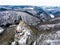 Aerial view rock with medieval castle on it near moselle river in Brodenbach winter with forest snow in the background