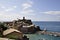 Aerial view on rock in the sea of picturesque Vernazza village resort from Cinque Terre in Italy