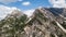 Aerial view of the rocks with mudflow and snow high in the Alpine mountains