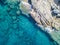 Aerial view of rocks on the sea. Swimmers, bathers floating on the water. eople sunbathing on the towel