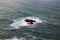 Aerial view rocks in the stormy ocean. Waves are braking on the cliffs. Overcast weather, stormy wind. Western point of Europe.