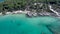 Aerial view of rocky beach with turquoise water in Halkidiki Kavourotripes, Greece, circular movement by drone, 4K resolution