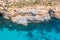 Aerial view rocky cliff coast and azure tropical sea