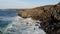 Aerial view of rocky cliffs and ocean with sunset tones. Lanzarote, Canary Islands.