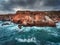 Aerial view of rocky coastline with crashing waves