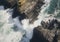 Aerial view of rocky coastline. Waves hitting in rocks. Birds eye view of the sea, cinimatic sea and moutain view. AI Generative