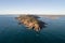 Aerial view of a rocky headland point plunging in the ocean