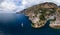 Aerial view of the rocky seashore of southern Italy. Boat. Incredible beauty panorama of mountains and sea. Travel and tourism.