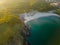 Aerial view of the rocky, wild coast of the Black Sea in Bulgaria, with cliffs, beaches, and green forests