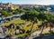 Aerial view of Roman historical buildings, Ancient Ruins, Coliseum and Imperial Forums Street Via dei Fori Imperiali