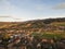 aerial view of rooftops houses and beautiful green hills