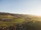 aerial view of rooftops houses and beautiful green hills with trees