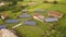 Aerial view of a row of  blue solar panels installed on the ground in residential area.