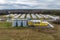 aerial view of rows of agro farms with silos and agro-industrial livestock complex