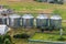 aerial view on rows of agro silos granary elevator with seeds cleaning line on agro-processing manufacturing plant for processing