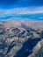 Aerial view of rugged mountainous terrain East of Los Angeles California in winter with snow capped peaks.