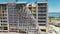 Aerial view of ruined by hurricane Ian construction scaffolding on high apartment building site