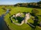 Aerial view of a ruined Norman conquest era castle in Wales Ogmore Castle