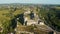 Aerial view of the ruins of a large medieval castle in Europe.