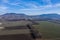 Aerial view of a rural landscape, farmland, village and hills