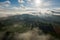 Aerial view of a rural landscape during sunrise in Tuscany. Rural farm, vineyards, green fields, sunlight and fog. Italy