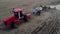 Aerial view of rural season work on agriculture farm field by industrial machine