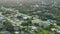 Aerial view of rural street traffic with driving cars in small town. American suburban landscape with private homes in