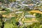 Aerial view of a rural town with well-groomed farms near Da Lata