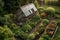 aerial view of a rustic greenhouse in a lush garden setting