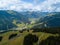 Aerial view from Saalbach to Hinterglemm and into the valley head of the Hinterglemm Mountains on a summer day in the