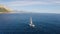 Aerial view of sailboat on blue sea at sunset in summer