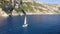 Aerial view of sailboat on blue sea at sunset in summer