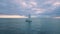 Aerial view on sailboat drifting in ocean bay after sunset, Oahu island, Hawaii