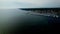 Aerial view sailboat enters the harbor bay at a picturesque harbor town