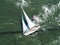 Aerial view of sailboat racing along