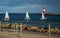 Aerial view of sailboats gliding across the tranquil waters of a harbor