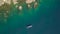 Aerial view sailing boat in blue sea and mountain cliff landscape. Sea landscape from above flying drone. Ship in
