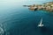 Aerial view of a sailing boat driving in blue sea.