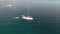 Aerial view of sailing boat in turquoise stunning sea in Halkidiki Greece, circular movement by drone