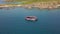 Aerial view sailing ship in blue sea and mountain cliff on shore. Tourist people swimming in clear sea water and boat