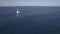 Aerial view of sailing white yacht in empty ocean blue water against clear sky, Mauritius Island